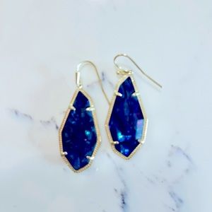 Kendra Scott drop earrings in colorful metallic dark blue with a majestic glow.